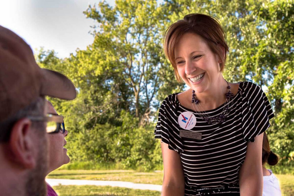 Photo of Iowa State Representative Heather Matson speaking to voters at a picnic.