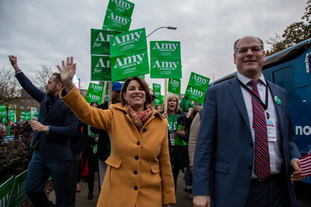 A photo of US Senator Amy Klobuchar leading a group of supporters to the Liberty and Justice Dinner