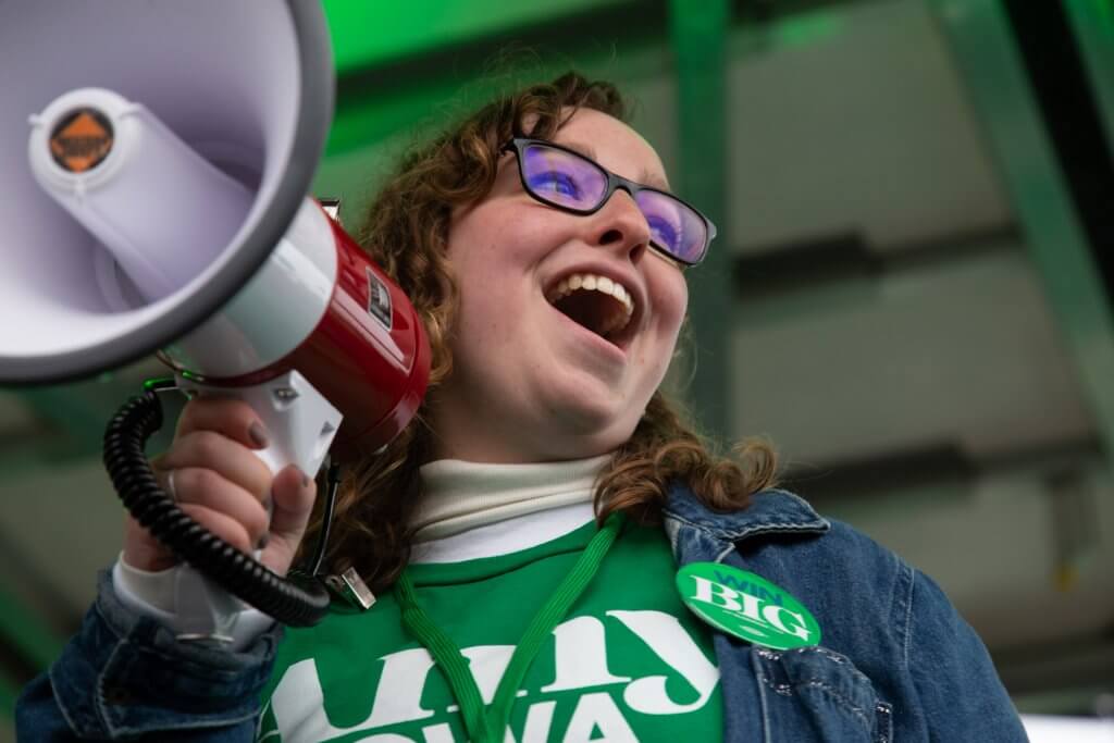 Photo of a staffer for US Senator Amy Klobuchar's presidential campaign holding a megaphone